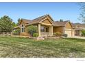 Beautiful single-Gathering home showcasing an inviting front porch, mature landscaping, and a well-maintained lawn at 11731 Center Dr, Longmont, CO 80504