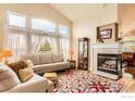 Bright living room featuring large windows, a fireplace, and comfortable seating area with lots of natural light at 11731 Center Dr, Longmont, CO 80504