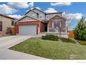 Charming two-story home featuring a brick and siding exterior with a well-maintained lawn and driveway at 12917 Fox St, Westminster, CO 80234
