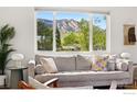 Inviting living room features a comfortable couch and scenic mountain views through a large window at 1350 Lehigh St, Boulder, CO 80305