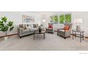 Bright living room featuring neutral decor, plush seating, and large windows offering pleasant views at 1429 Linden St, Longmont, CO 80501