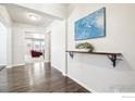 Elegant foyer featuring hardwood floors and a stylish decorative shelf at 1471 Sabin Ct, Berthoud, CO 80513