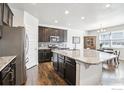 Modern kitchen with stainless steel appliances, granite countertops, and a large island at 1471 Sabin Ct, Berthoud, CO 80513