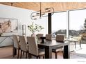 Elegant dining room with modern chandelier, dining table, and a beautiful view of the outdoors at 1575 Linden Dr, Boulder, CO 80304