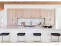 Bright, open kitchen with a long center island, stylish seating, and light wood cabinets at 1575 Linden Dr, Boulder, CO 80304