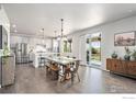 Modern kitchen with stainless steel appliances, an island, and wood floors at 17101 Pecos St, Broomfield, CO 80023