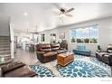 Bright open-concept living room with modern furnishings and views of the lush outdoors at 17101 Pecos St, Broomfield, CO 80023