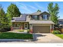 Charming two-story home with solar panels and a well-manicured front yard at 180 Mercator Ave, Lafayette, CO 80026