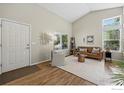 Cozy living room with abundant natural light, hardwood floors and modern furniture at 180 Mercator Ave, Lafayette, CO 80026
