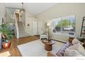 Inviting foyer with staircase leading to the upper level and open-concept living area at 180 Mercator Ave, Lafayette, CO 80026
