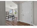 Inviting entryway with wood floors, a view of a home office, and a bright white front door at 1923 High Plains Dr, Longmont, CO 80503