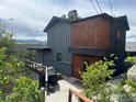 View of the two-story home featuring wood accents and a walkout balcony with mountain views at 22598 Westview Ave, Golden, CO 80401