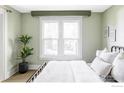 Light filled bedroom with black metal bedframe and crisp white comforter at 2424 4Th St, Boulder, CO 80304