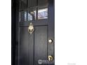 Detailed view of the black front door with decorative knocker and hardware at 2424 4Th St, Boulder, CO 80304