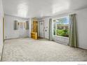 Bright living room featuring an open floorplan, neutral carpeting, and large windows at 245 S 13Th Ave, Brighton, CO 80601
