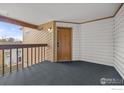 Wide angle of the balcony with black carpet and siding walls and wood trim at 2962 Shadow Creek Dr # 308, Boulder, CO 80303