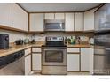 This kitchen features light wood cabinets, stainless appliances, and wood countertops at 2962 Shadow Creek Dr # 308, Boulder, CO 80303