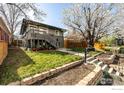 Home exterior with a small porch, green grass and well maintained landscaping at 3233 Meade St, Denver, CO 80211