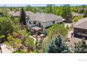Backyard aerial view shows an outdoor patio with pergola and privacy fence at 3931 Stonegrass Pt, Broomfield, CO 80023