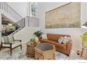 Cozy living room with high ceilings, staircase and stylish decor at 3931 Stonegrass Pt, Broomfield, CO 80023