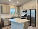 Modern kitchen featuring stainless steel appliances and center island at 401 Bonneville Ave, Fort Lupton, CO 80621