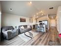 Open-concept living room with lots of natural light and hardwood floors at 401 Bonneville Ave, Fort Lupton, CO 80621