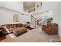 Bright living room with high ceilings, staircase, and open view to dining room at 4056 Perth St, Denver, CO 80249