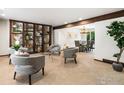 Bright living room featuring stylish grey chairs, modern decor, and an open layout leading to the dining area at 4311 Pali Way, Boulder, CO 80301