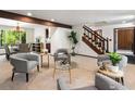Open-concept living room with comfortable seating, a view of the staircase, and a glimpse into the kitchen at 4311 Pali Way, Boulder, CO 80301