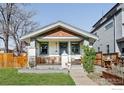 Charming single story house with a cozy front porch and attractive landscaping at 4401 Vrain St, Denver, CO 80212