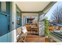 Covered porch with bench seating, wood decking, and charming architectural details at 4401 Vrain St, Denver, CO 80212