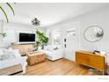 Cozy living room with hardwood floors, comfortable seating, and an open layout at 4401 Vrain St, Denver, CO 80212