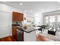 Modern kitchen with stainless steel appliances, dark countertops, and an adjacent living room at 4555 13Th St # 2C, Boulder, CO 80304