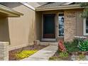 Close-up of front entrance with brick accents and well-kept landscaping, creating a warm welcome at 4961 W 98Th Ave, Westminster, CO 80031