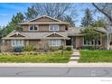 Charming two-story home with meticulously landscaped front yard and traditional architectural details at 4961 W 98Th Ave, Westminster, CO 80031