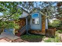 Two-story home featuring blue siding, stone accents, and inviting front entrance at 5646 Rim Rock Ct, Boulder, CO 80301