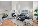 Bright living room featuring high ceilings, large windows, and modern decor at 5646 Rim Rock Ct, Boulder, CO 80301