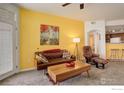 Bright living room featuring a comfortable leather couch and retro accents at 5723 N Gibralter Way # 205, Aurora, CO 80019