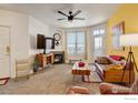 Cozy living room boasts a fireplace, fan and a sliding glass door at 5723 N Gibralter Way # 205, Aurora, CO 80019