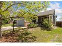 Well-maintained single-Gathering home with a lush green lawn and mature trees at 6054 Ulysses Ave, Firestone, CO 80504
