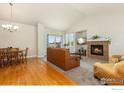 Inviting living room with a fireplace, plush seating, and ample natural light at 6054 Ulysses Ave, Firestone, CO 80504