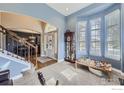 Welcoming entryway with staircase, hardwood floors, and natural light at 6212 Saddleback Ave, Firestone, CO 80504