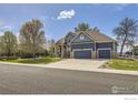 Spacious two-story home with a three-car garage and well-maintained lawn at 6212 Saddleback Ave, Firestone, CO 80504