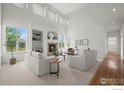 Spacious living room with a fireplace, built-in shelves, large windows, and neutral paint at 708 Teal Cir, Longmont, CO 80503