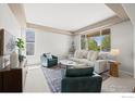 Bright living room with neutral decor, plush seating, and large windows offering scenic views at 708 Teal Cir, Longmont, CO 80503