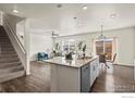 Open-concept layout featuring the kitchen island, which connects the living and dining areas at 902 William Way, Brighton, CO 80603