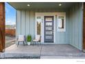 Inviting covered front porch with modern door and comfortable seating arrangement at 919 Russell St, Golden, CO 80401