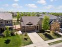 An aerial view of a single-Gathering home nestled in a neighborhood with mature trees and green lawns at 950 Sumner Way, Erie, CO 80516