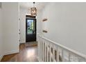 Bright entry hallway with hardwood floors, coat hooks, and white trim at 950 Sumner Way, Erie, CO 80516