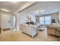 Bright living room featuring neutral tones, plush sofas, and elegant lighting fixtures at 10048 Granby St, Commerce City, CO 80022